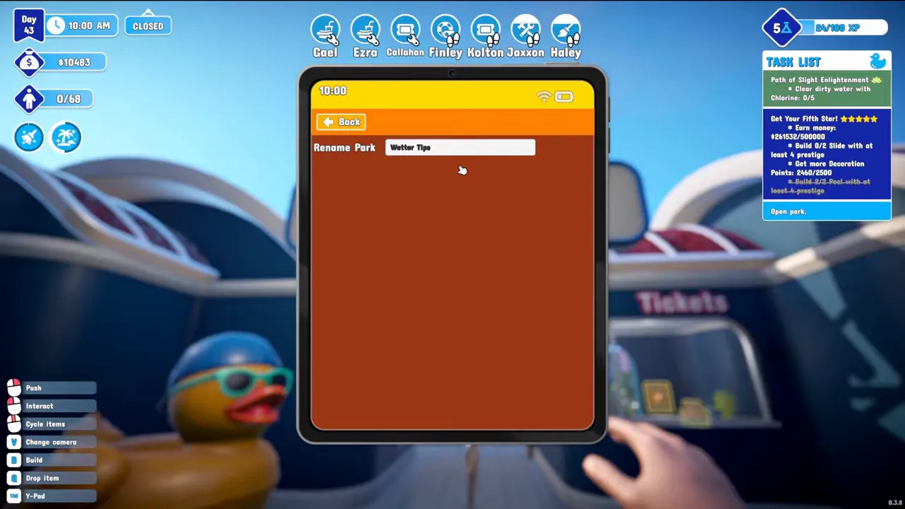 The in-game tablet open on a Rename Park field with Wetter Tips typed in, held in front of the park entrance